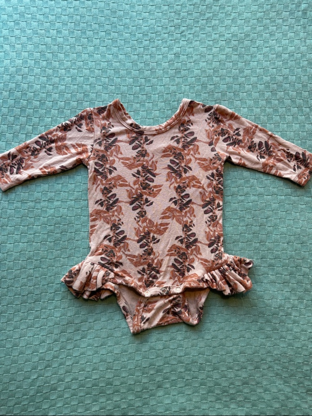 Kate Quinn ruffle leg long sleeve bodysuit